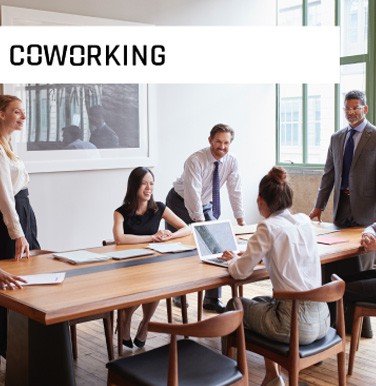 Coworking people standing and sitting while working